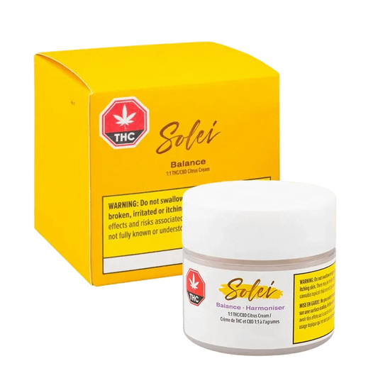 A close-up of the Balance Body Cream packaging, featuring a vibrant yellow label with prominent text and a cannabis leaf icon.