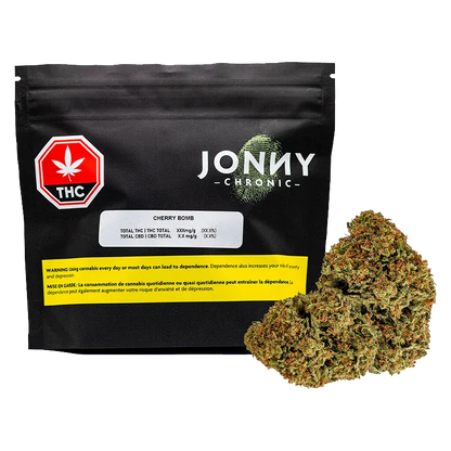 Front-facing shot of a black pouch and a 28 g bud pile labeled Jonny Chronic Cherry Bomb against a white background.