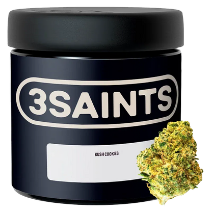 Front-facing shot of a black 3SAINTS Kush Cookies jar with bold logo and a single cannabis bud positioned at the lower right.
