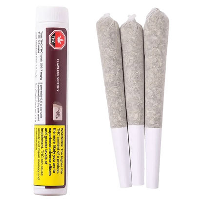 Close-up of the Flawless Victory Pre Rolled 3 x 0.5 g packaging with warning details, presented at a slight angle against a dark backdrop.