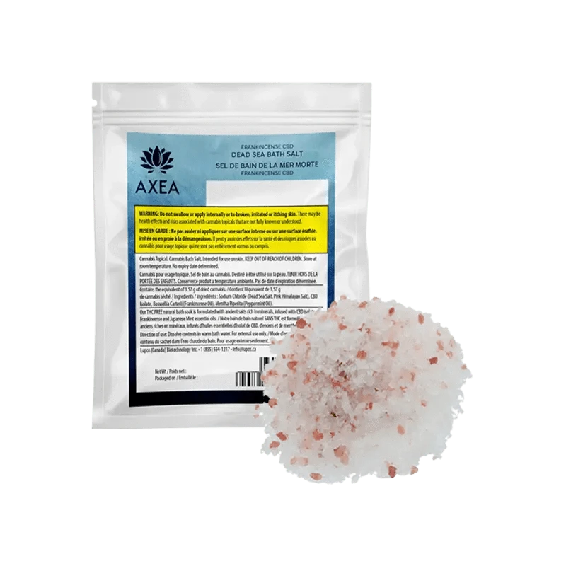 A front view of Frankinsence Dead Sea Pink Himalayan Bath Salt in a clear container with a label featuring branding and text details.