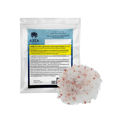 A front view of Frankinsence Dead Sea Pink Himalayan Bath Salt in a clear container with a label featuring branding and text details.