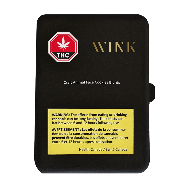 Top-down view of the matte black package labeled "Craft Animal Face Cookies PR 5 x 1 g" with a gold WINK logo, red THC stop sign, and a yellow Health Canada warning panel.