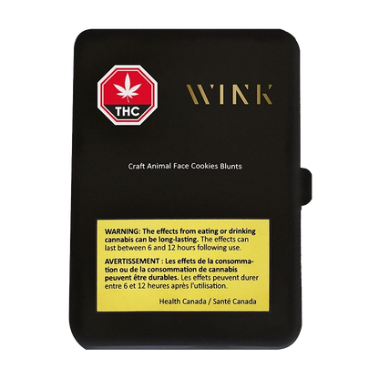 Top-down view of the matte black package labeled "Craft Animal Face Cookies PR 5 x 1 g" with a gold WINK logo, red THC stop sign, and a yellow Health Canada warning panel.