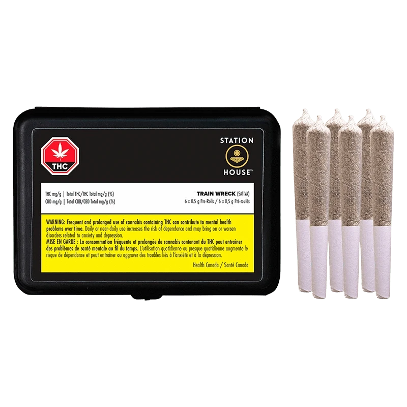 Right-side view of five rolled pre-rolls next to a black tin labeled "Trainwreck PR 6 x 0.5 g" showing warning text and Station House branding.