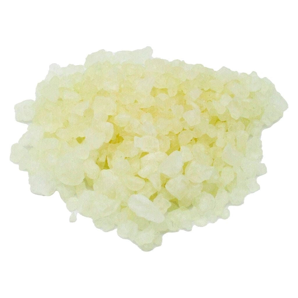 CBD Bath Salts shown in a close-up, top-down shot of a pile of crystalline granules against a white background.