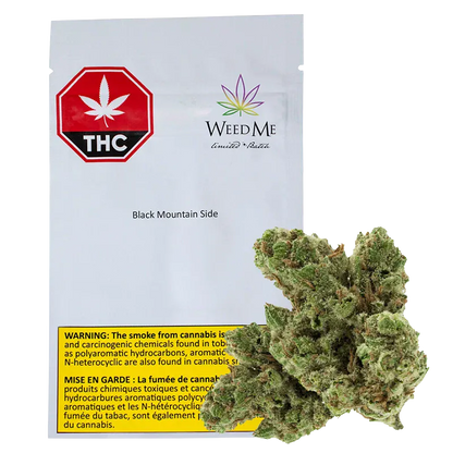 Front view of a white pouch labeled "Black Mountain Side" from WeedMe with a red THC octagon at top left and a cannabis bud placed in front.