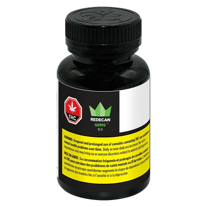 Front three-quarter view of a black bottle labeled "TIL Gems 10:0 Softgels Hybrid 100 caps - Redecan" with a white and yellow warning label and a stylized green leaf logo.