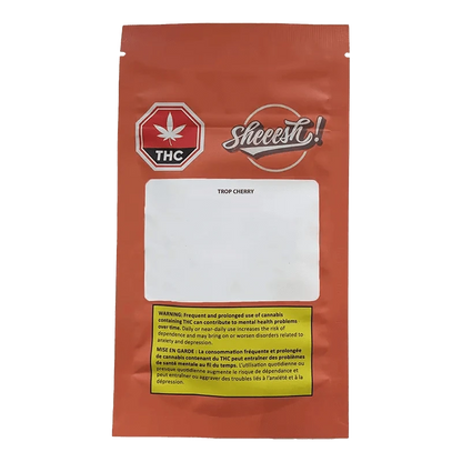 Front view of the Trop Cherry package with a warning message and cannabis leaf design against a bright orange background.
