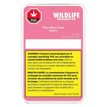 Rectangular front-facing tin with a pink label reading Wildlife Cannabis Co. Foxy Haze Face PR 10 x 0.3 g above a yellow bilingual THC health warning.
