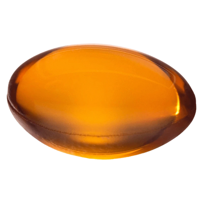 Top-down close-up of a glossy amber softgel labeled Mega Packs Bal THC:CBD 1:1, shown against a plain white background.