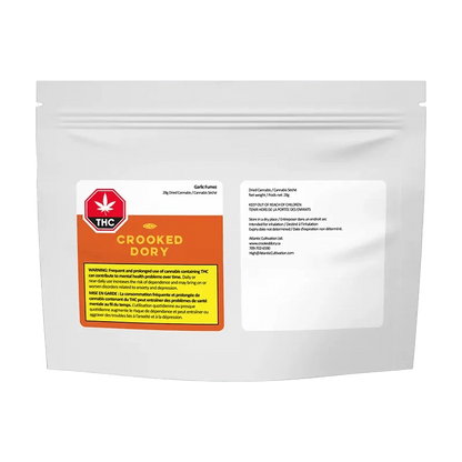 Close-up of the Garlic Fumez package with a warning label, shot at a slight angle against a dark background.