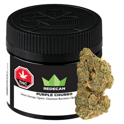 A close-up of the Purple Churro, displaying a dark green cannabis bud against a neutral background.