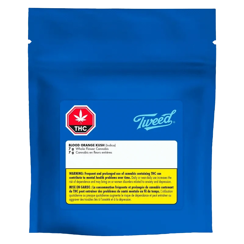 A close-up of Tweed Blood Orange Kush packaging, displaying bold branding over a light orange background.