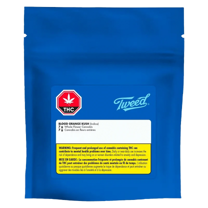 A close-up of Tweed Blood Orange Kush packaging, displaying bold branding over a light orange background.