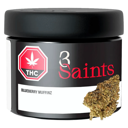 Close-up of Blueberry Muffinz, showing a pile of plant matter arranged in front of a dark, textured background.