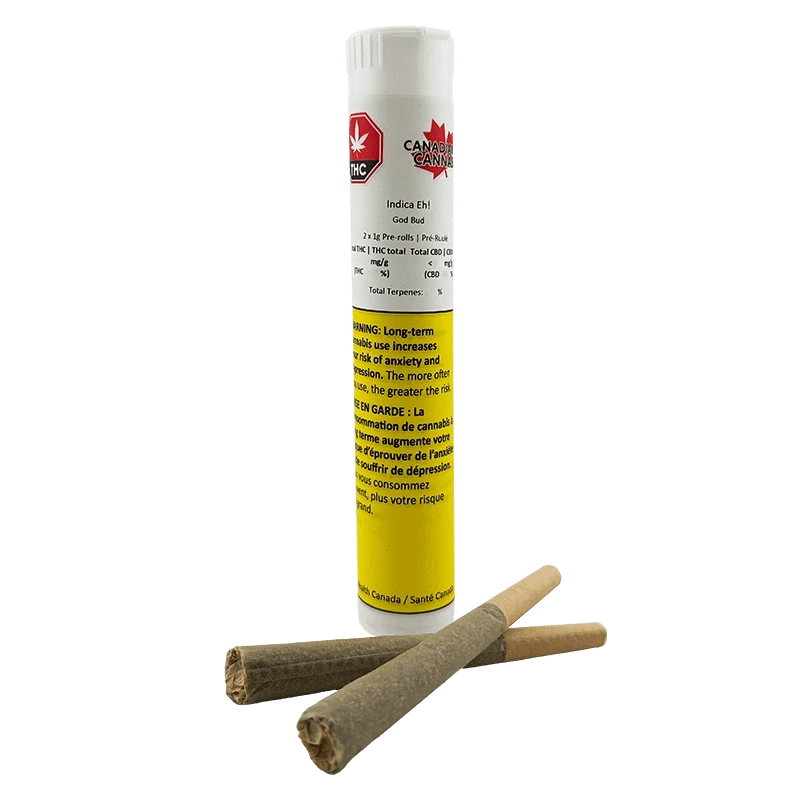 Straight-on shot of a white-and-yellow tube labeled Indica Eh! PR 2 x 1 g standing behind two rolled pre-rolls lying crossed in front.