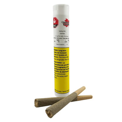 Straight-on shot of a white-and-yellow tube labeled Indica Eh! PR 2 x 1 g standing behind two rolled pre-rolls lying crossed in front.