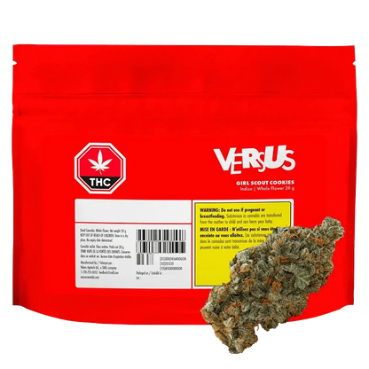 Front-facing red pouch labeled Versus Girl Scout Cookies with a cannabis bud resting against its lower right corner.