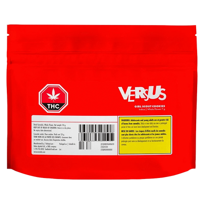 Rear view of the bright red Versus Girl Scout Cookies pouch with white logo, THC symbol, barcode and a yellow warning panel.