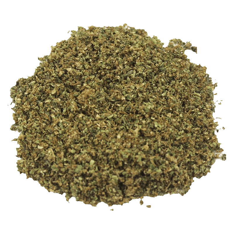 Top-down view of a loose, finely ground green-brown pile of "Pure Milled Sativa" against a plain white background.