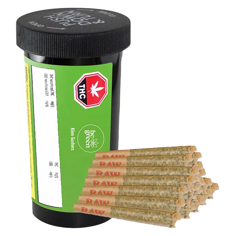 Three-quarter view of a black pill-style jar labeled Alien Gushers PR 20 x 0.5 g with a green label, shown beside a stacked pyramid of pre-rolled joints.