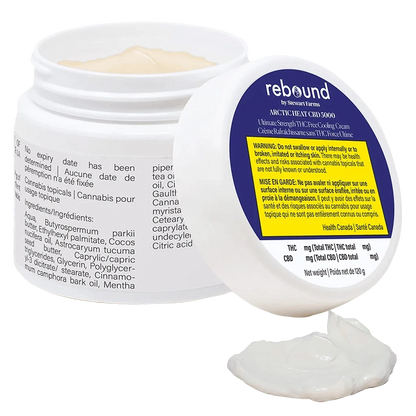 White jar of Arctic Heat Cbd 5000 Cooling Cream shown open at a three-quarter angle with the lid propped forward and a dollop of cream in front.