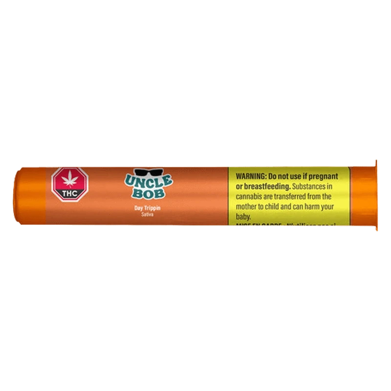 Side-on view of the orange cylindrical packaging labeled "Uncle Bob Day Trippin PR 1 x 0.5 g" with a THC symbol and a yellow warning panel.