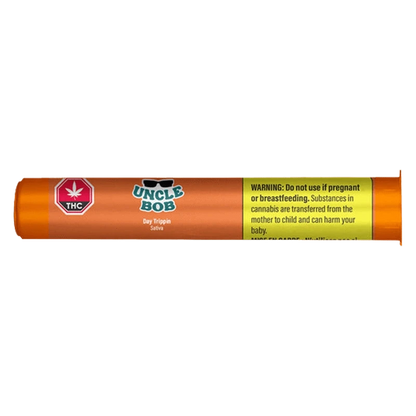 Side-on view of the orange cylindrical packaging labeled "Uncle Bob Day Trippin PR 1 x 0.5 g" with a THC symbol and a yellow warning panel.