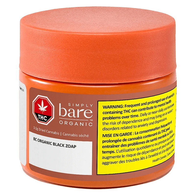 Three-quarter front view of the Simply bare Organic BC Organic Black Zoap jar with an orange lid and yellow warning label.