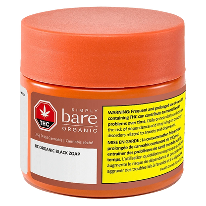 Three-quarter front view of the Simply bare Organic BC Organic Black Zoap jar with an orange lid and yellow warning label.