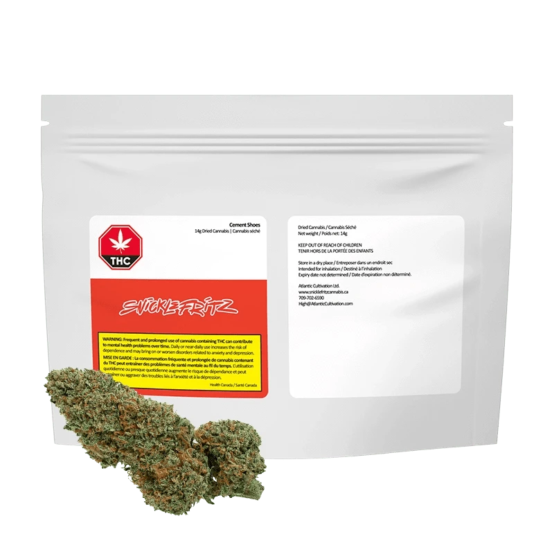Front-facing shot of the Cement Shoes pouch by Snickfritz, a white resealable bag with red label and cannabis buds arranged in front.
