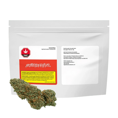 Front-facing shot of the Cement Shoes pouch by Snickfritz, a white resealable bag with red label and cannabis buds arranged in front.