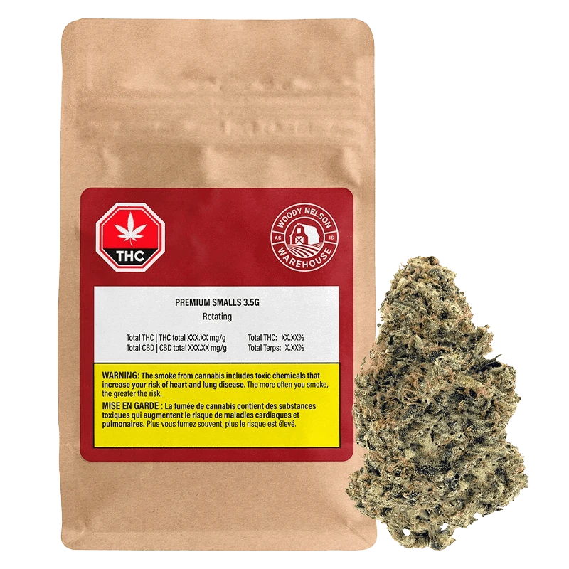 Front view of a kraft pouch and nearby bud showing the Premium Smalls 3.5 g label and a red THC badge on the package.