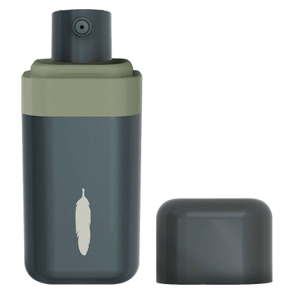Front view of the THC Dose Control Spray Oil bottle in muted green and charcoal with its cap removed, showing a small spray nozzle and feather logo.