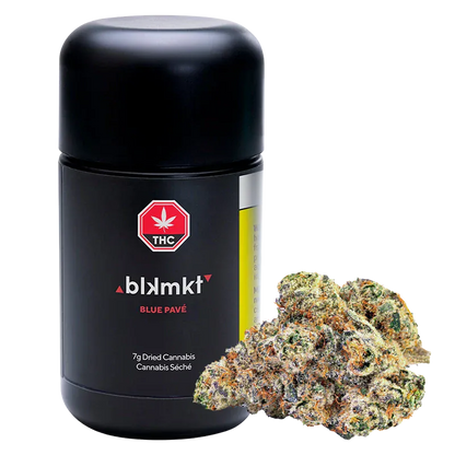 Front-facing shot of the blkmkt Blue Pavé 7g black canister with a pile of frosty cannabis nugs at its base.