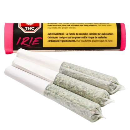 Close-up of three pre-rolled joints fanned in the foreground with an Irie PR 3 x 0.5 g tubular pink and black package blurred behind.