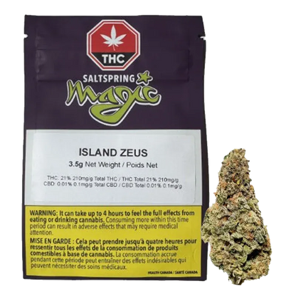 Front view of the Saltspring Magic Island Zeus 3.5 g pouch with label visible and a cannabis bud placed to its right.
