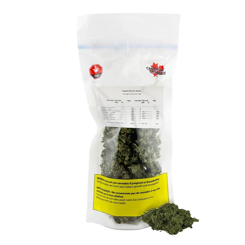 Clear front-facing photo of a sealed bag of Organic Electric Skunk showing green buds through the lower pouch and a yellow warning label.