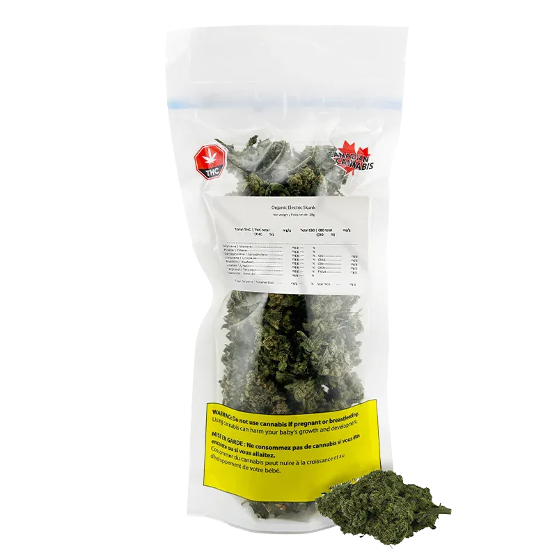 Front-facing photo of a clear resealable bag of Organic Electric Skunk showing dense green buds, a white product label and a yellow warning panel.