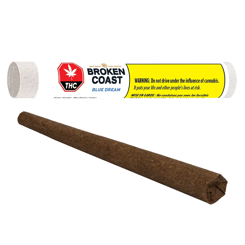 Angled close-up of a brown pre-rolled cone in front of a horizontal white tube labeled Broken Coast Blue Dream.
