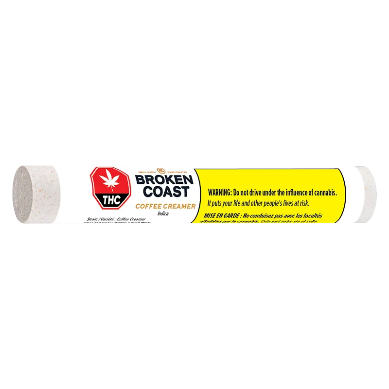 Horizontal front view of a white tube labeled Broken Coast Coffee Creamer PR 3 x 0.5 g with a yellow warning panel.