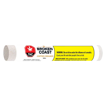 Horizontal front view of a white tube labeled Broken Coast Coffee Creamer PR 3 x 0.5 g with a yellow warning panel.