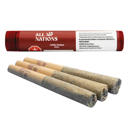 Angled close-up of three rolled joints in front of a red tube labeled "Cadillac Rainbow PR 3 x 0.5 g" from All Nations.