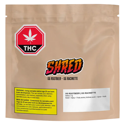 Front-facing shot of a tan pouch labeled "OG Rootbeer" with a colorful SHRED logo, THC warning icon, and ingredient panel.