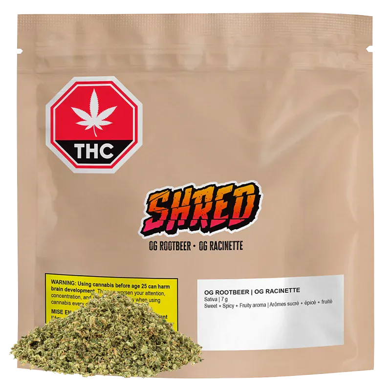 Front view of a tan resealable pouch labeled "OG Rootbeer" with a colorful SHRED logo, THC warning icon, and a small pile of loose dried herb at the base.