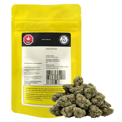 Front view of the Snow Globe 28 g yellow pouch labeled "Snow Globe" with a pile of green cannabis buds in front.