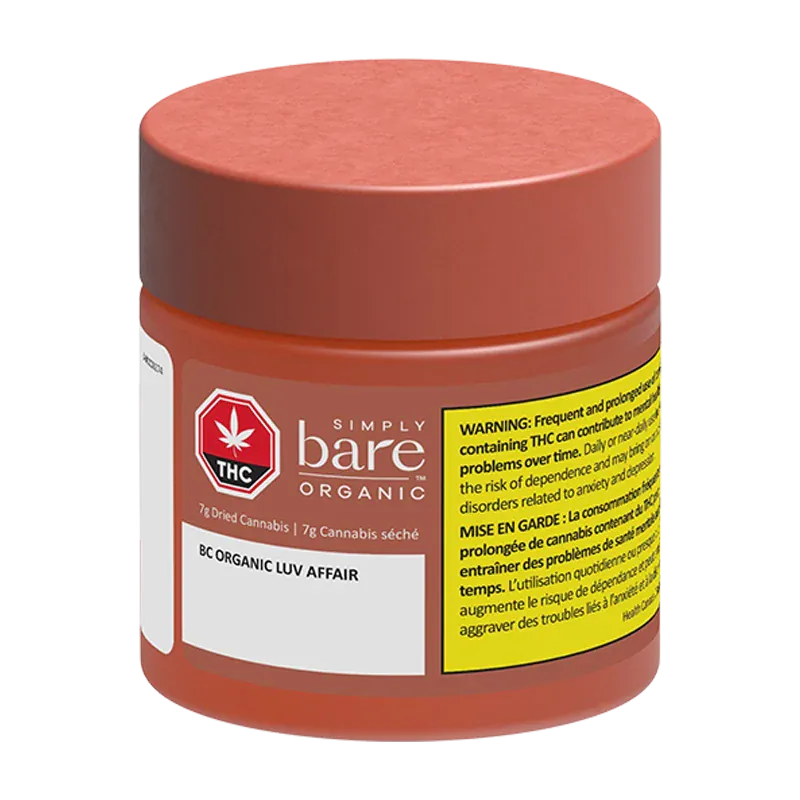 Front three-quarter view of a small red jar labeled "BC Organic Luv Affair" from Simply Bare Organic with a yellow warning panel.
