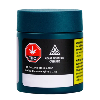 Front view of a teal jar labeled "BC Organic Bling Blaow" from Coast Mountain Cannabis with a black product label and warning tab.
