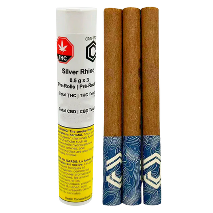 Three pre-rolls with blue patterned tips standing beside a white labeled tube reading Silver Rhino PR 3 x 0.5 g.